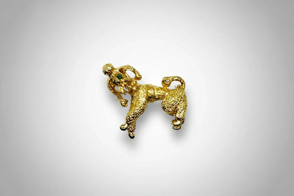 Perfect for vintage jewelry lovers: our Gold Poodle Brooch provides a cute, textured design with green rhinestone eyes that add playful charm. Shop today!