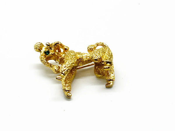 Perfect for vintage jewelry lovers: our Gold Poodle Brooch provides a cute, textured design with green rhinestone eyes that add playful charm. Shop today!