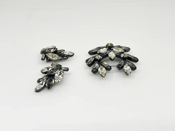 This is a gorgeous set of pin and earrings made with marquise and round shaped rhinestones in gray and clear. They are nestled in a layered, dark metal setting. The stones are standout bright and very sparking, great condition other than some wear on reverse. The earrings are clip on, hinge back.