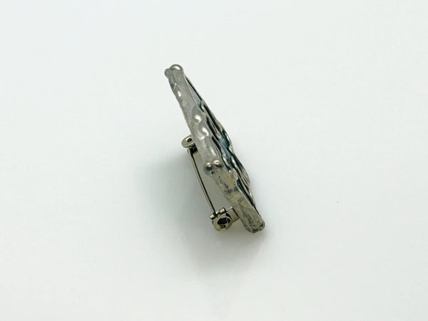 This charming stained glass pin celebrates individuality with a puzzle piece design crafted using authentic Tiffany-style copper foil work. Vibrant green and blue glass pieces are carefully soldered together to create a wearable conversation starter that doubles as meaningful advocacy.