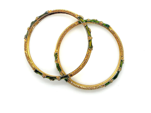 A pair of traditional Indian gold-plated bangles showcasing intricate filigree work and vibrant grass green enamel detailing.