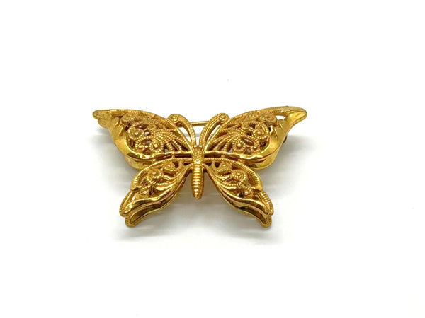 Vintage Miriam Haskell jewelry collection: A signed Russian gold-plated filigree butterfly pin from the 1950s with detailed openwork wings.