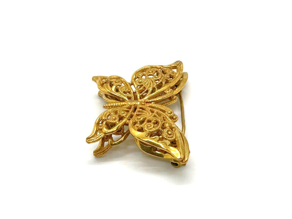 Vintage Miriam Haskell jewelry collection: A signed Russian gold-plated filigree butterfly pin from the 1950s with detailed openwork wings.