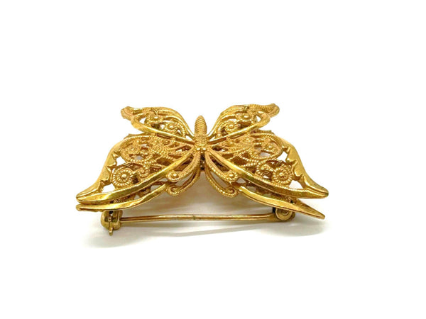 Vintage Miriam Haskell jewelry collection: A signed Russian gold-plated filigree butterfly pin from the 1950s with detailed openwork wings.