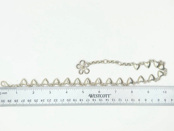 This charming necklace features heart shapes with sparkling round rhinestones at the center. Flip it over to reveal solid hearts with a sleek brushed finish—wear it whichever way suits your mood! Measuring 16" long, it’s secured with an adjustable whimsical flower clasp and a trusty lobster closure for a fun, flirty touch.