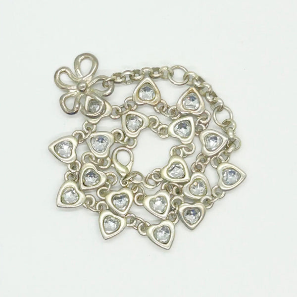 This charming necklace features heart shapes with sparkling round rhinestones at the center. Flip it over to reveal solid hearts with a sleek brushed finish—wear it whichever way suits your mood! Measuring 16" long, it’s secured with an adjustable whimsical flower clasp and a trusty lobster closure for a fun, flirty touch.