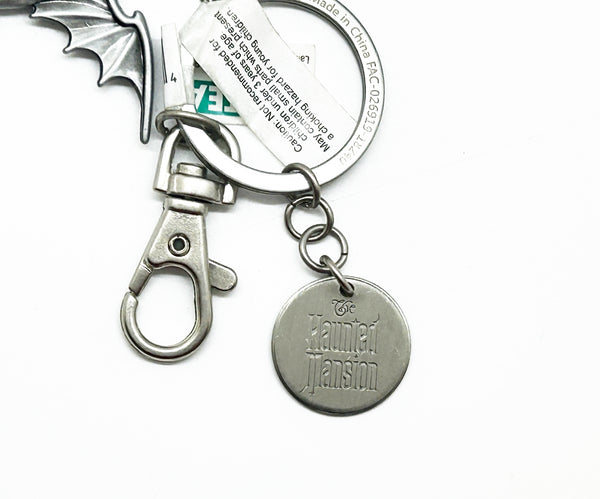 Perfect for Disney fans: our Disney Haunted Mansion Bat Key Chain provides a collectible, durable, bat wing design with iconic logo. Shop today!