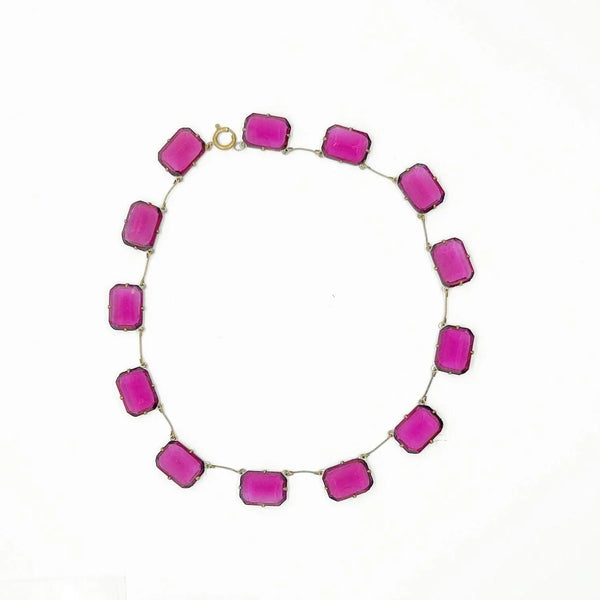 Admire the timeless beauty of our Graceful Vintage Czech Violet Clear Stones Necklace. Handcrafted with thirteen emerald cut purple clear stones encased in intricately detailed frames, this elegant necklace is a true work of art. With a length of approximately 15", it is a delicate and sophisticated addition to any outfit. Experience luxury and exclusivity with this exquisite piece, in very good vintage condition. Free Shipping