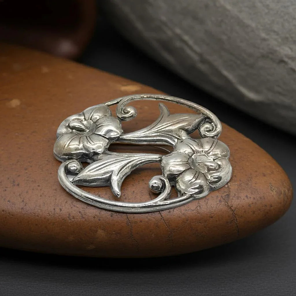 Perfect for art nouveau lovers: our Vintage Oval Sterling Silver Art Nouveau Floral Brooch provides intricate floral elegance and timeless style. Shop today!