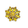 This charming Antique Open Back Golden Stone Brooch is a dazzling tribute to vintage glamour. Sparkling faceted marquise stones with open backs catch the light from every angle, creating a rich, shimmering display centered around a brilliant round stone.