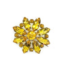 This charming Antique Open Back Golden Stone Brooch is a dazzling tribute to vintage glamour. Sparkling faceted marquise stones with open backs catch the light from every angle, creating a rich, shimmering display centered around a brilliant round stone.