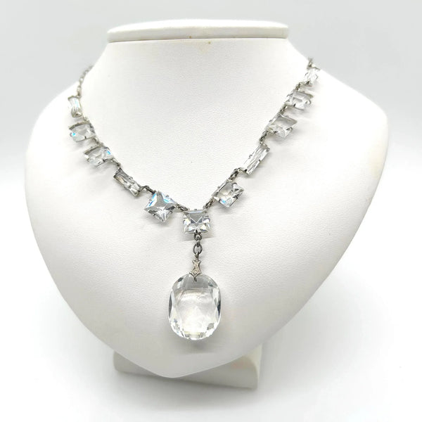This is a magnificent sterling and crystal drop necklace from the Art Deco Era. It is in very good condition with minor to no flea bites or worn edges to the stones. The piece is stamped sterling on the clasp and has normal wear to the sterling which makes the stones pop.