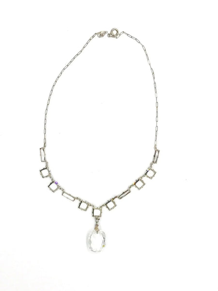 This is a magnificent sterling and crystal drop necklace from the Art Deco Era. It is in very good condition with minor to no flea bites or worn edges to the stones. The piece is stamped sterling on the clasp and has normal wear to the sterling which makes the stones pop.