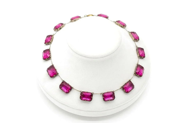 Admire the timeless beauty of our Graceful Vintage Czech Violet Clear Stones Necklace. Handcrafted with thirteen emerald cut purple clear stones encased in intricately detailed frames, this elegant necklace is a true work of art. With a length of approximately 15", it is a delicate and sophisticated addition to any outfit. Experience luxury and exclusivity with this exquisite piece, in very good vintage condition. Free Shipping