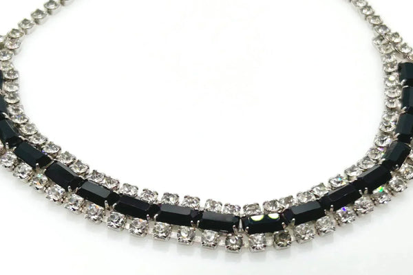 This is a beautiful vintage rhinestone necklace or choker set with a line of sideways baguettes in black paired with meticulously prong-set round white rhinestones on top and bottom.