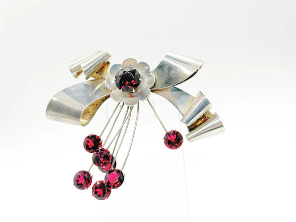 Perfect for vintage jewelry lovers: our Sterling by Jordan 1940s Red Stone Vintage Bow Brooch provides timeless elegance with striking red stones. Shop today!