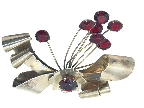 Perfect for vintage jewelry lovers: our Sterling by Jordan 1940s Red Stone Vintage Bow Brooch provides timeless elegance with striking red stones. Shop today!