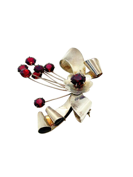 Perfect for vintage jewelry lovers: our Sterling by Jordan 1940s Red Stone Vintage Bow Brooch provides timeless elegance with striking red stones. Shop today!