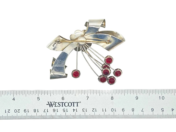 Perfect for vintage jewelry lovers: our Sterling by Jordan 1940s Red Stone Vintage Bow Brooch provides timeless elegance with striking red stones. Shop today!