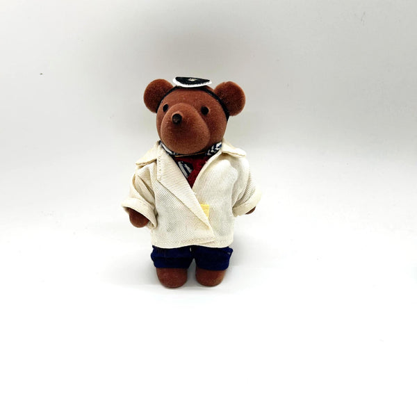 A small brown plush teddy bear dressed up as a medical doctor