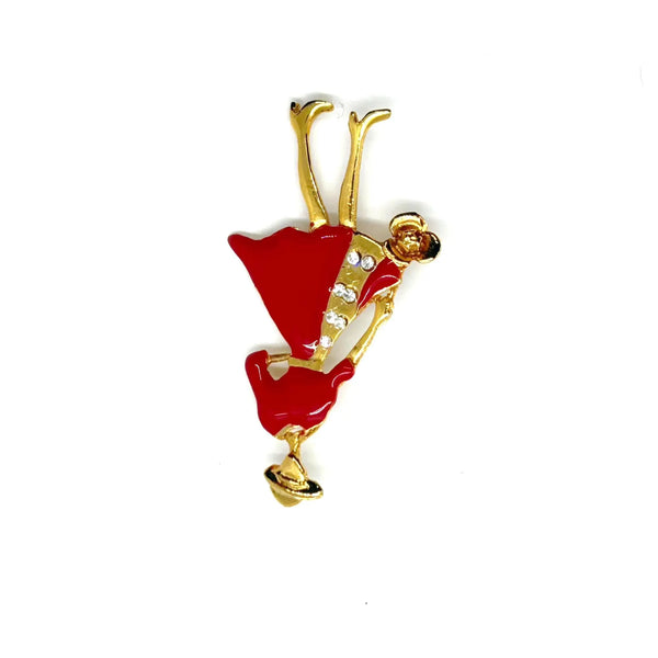 The highlighted item is a vintage enameled lady figural brooch, showing a stylish woman dressed in a vibrant red coat or dress with a wide-brimmed hat. 