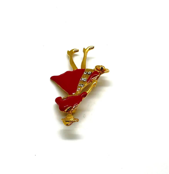 The highlighted item is a vintage enameled lady figural brooch, showing a stylish woman dressed in a vibrant red coat or dress with a wide-brimmed hat. 