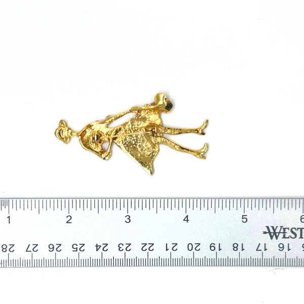 The highlighted item is a vintage enameled lady figural brooch, showing a stylish woman dressed in a vibrant red coat or dress with a wide-brimmed hat. 