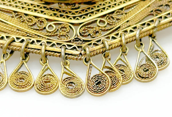 Vintage Israel Filigree Brooch/pendant with Tassels and Smokey Quartz center Stone.It has a geometric shape with tiny filigree drops at the bottom, and a large, faceted oval stone is the centerpiece. The metal is extremely intricate and detailed, both front and back.