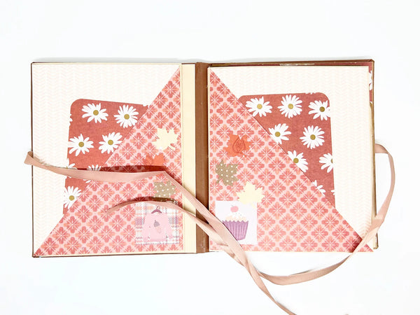 This charming album showcases autumn leaves, seasonal flowers, and delightful illustrations of warm drinks. Centered around family, home, fall, and coffee, it includes dedicated spaces for your personal notes and mementos, allowing you to customize it easily.