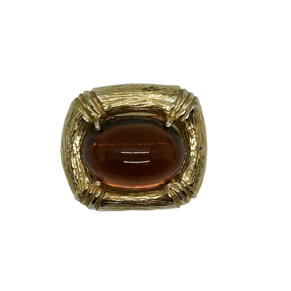 Indulge in the warm, honeyed glow of this delightful Les Bernard brooch. Rich amber glass catches the light like liquid caramel, nestled within a brushed gold-tone squared setting that frames it to perfection.