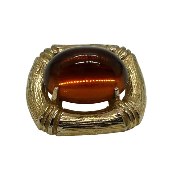 Indulge in the warm, honeyed glow of this delightful Les Bernard brooch. Rich amber glass catches the light like liquid caramel, nestled within a brushed gold-tone squared setting that frames it to perfection.