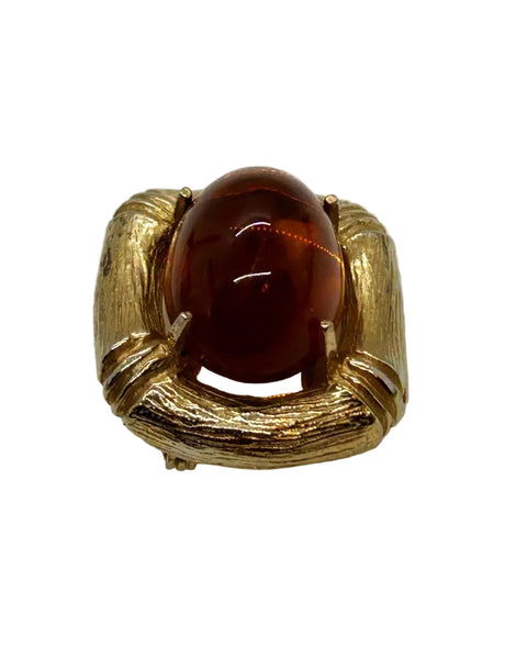 Indulge in the warm, honeyed glow of this delightful Les Bernard brooch. Rich amber glass catches the light like liquid caramel, nestled within a brushed gold-tone squared setting that frames it to perfection.