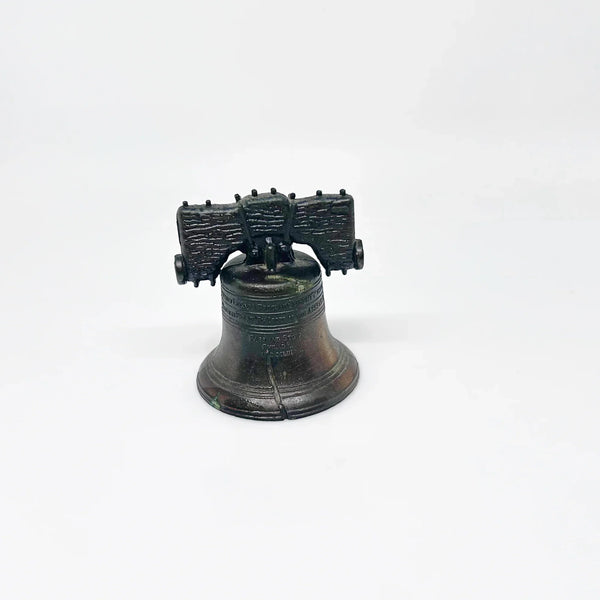 Bring a touch of American history to your home with this charming, miniature metal replica of the iconic Liberty Bell. Standing at a delightful 2.5 inches tall, this piece beautifully captures the essence of freedom and independence, a symbol that has resonated since the American Revolution.