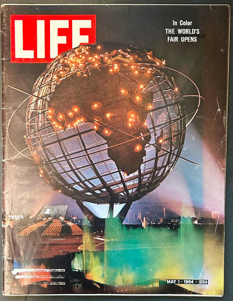 The front cover of the May 1, 1964 issue of LIFE Magazine, featuring a night view of the illuminated Unisphere globe sculpture at the opening of the New York World's Fair. The classic red LIFE logo is visible in the top left corner, with the headline 'In Color: THE WORLD'S FAIR OPENS' on the right