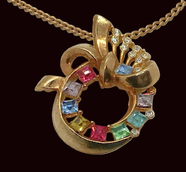 Adorned with pastel rhinestones and a delicate flourish, this circular pendant exudes elegance. The gold tone chain adds a touch of luxuriousness, and the signature Lisner fold over clasp ensures a secure and comfortable fit. 