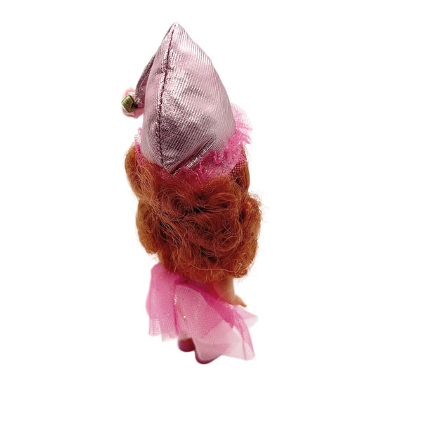 Kelly appears as Lullaby Munchkin doll from The Wizard of Oz collection. This charming figure dressed as the iconic Lullaby Munchkin character.