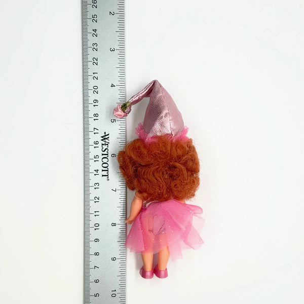 Kelly appears as Lullaby Munchkin doll from The Wizard of Oz collection. This charming figure dressed as the iconic Lullaby Munchkin character.