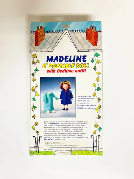 From Eden Toys, Inc., comes this 8" poseable Madeline doll, complete with her school dress, blue coat, socks, shoes, pantes and iconic yellow hat. night clothes. Attention to detail shows in the appendix scar described in the books and fully combable hair. She also has a change of night clothes, a blue nightgown and white slippers.