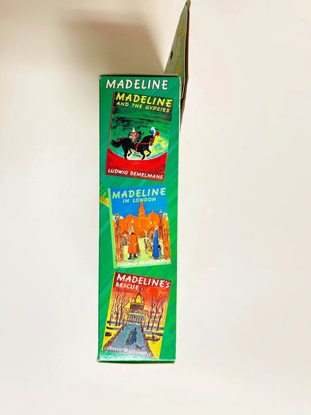 From Eden Toys, Inc., comes this 8" poseable Madeline doll, complete with her school dress, blue coat, socks, shoes, pantes and iconic yellow hat. night clothes. Attention to detail shows in the appendix scar described in the books and fully combable hair. She also has a change of night clothes, a blue nightgown and white slippers.