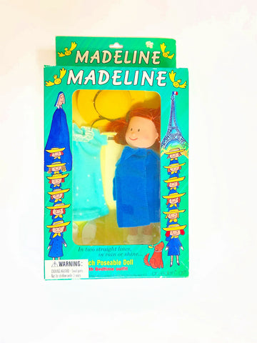 From Eden Toys, Inc., comes this 8" poseable Madeline doll, complete with her school dress, blue coat, socks, shoes, pantes and iconic yellow hat. night clothes. Attention to detail shows in the appendix scar described in the books and fully combable hair. She also has a change of night clothes, a blue nightgown and white slippers.