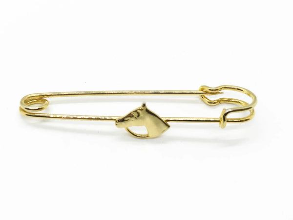 This exquisite gold-tone horse head brooch is perfect for adorning blouses, kilts, or skirts with equestrian elegance. This sophisticated accessory, measuring .25" wide by 2.5" long, presents in impeccable near-mint condition