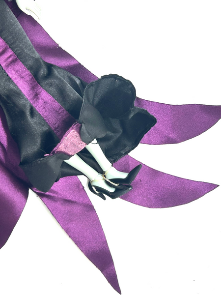 Disney Store Maleficent 12-inch classic fashion doll wearing her iconic black and burgundy robe with curved horns headpiece, isolated on a solid white background.