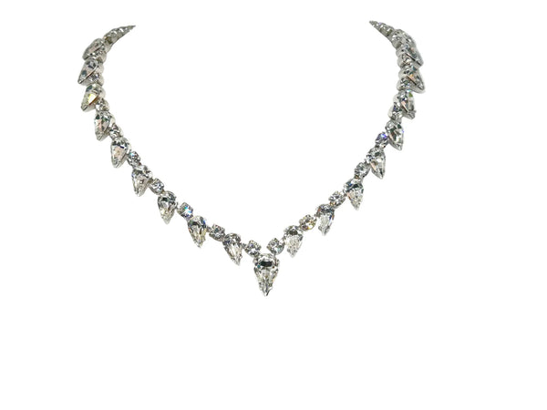 Discover the magic of this stunning vintage Superb Kramer Rhinestone Necklace, where icy brilliance meets timeless elegance. Adorned with crystal-clear marquise and pear-cut stones nestled in gleaming rhodium-plated silver-tone metal, this 14.5" beauty practically dances with light. 