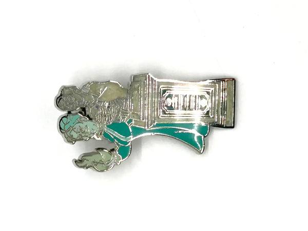 This pin is a 2012 Disney Parks Walt Disney World Haunted Mansion Interactive Graveyard Queue "Cousin Maude and Uncle Jacob's Statue" mystery pin.