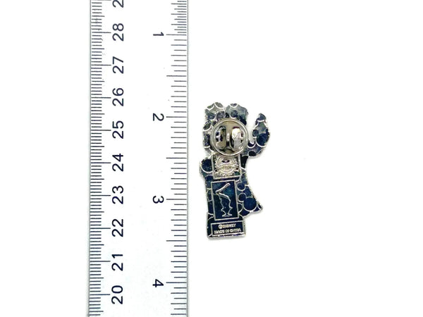 This pin is a 2012 Disney Parks Walt Disney World Haunted Mansion Interactive Graveyard Queue "Cousin Maude and Uncle Jacob's Statue" mystery pin.