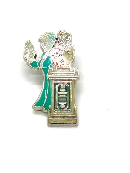 This pin is a 2012 Disney Parks Walt Disney World Haunted Mansion Interactive Graveyard Queue "Cousin Maude and Uncle Jacob's Statue" mystery pin.