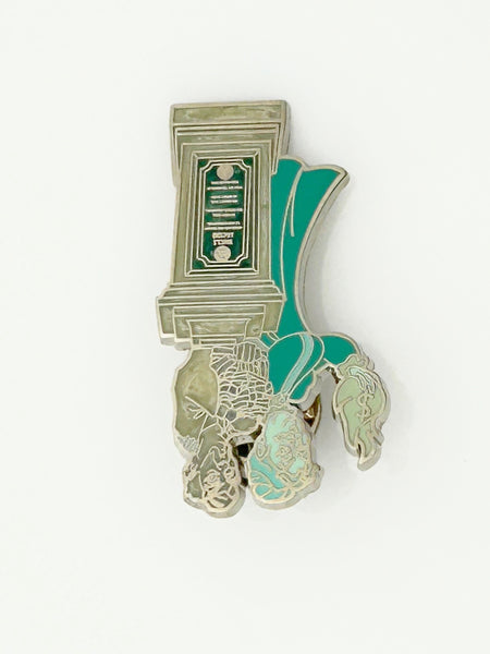 This pin is a 2012 Disney Parks Walt Disney World Haunted Mansion Interactive Graveyard Queue "Cousin Maude and Uncle Jacob's Statue" mystery pin.