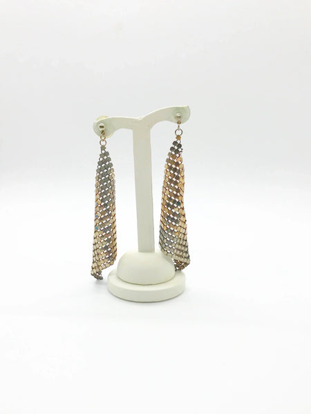 These are elegant and eye catching- and even more special once you give them a second and third look. Each tiny round disc is attached to the others by even more tiny rings. They are set in a triangular mesh that drapes and reflects the light.