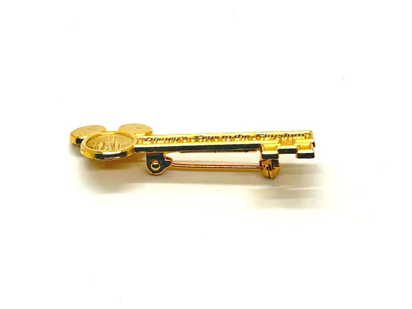 This enchanting gold-tone pin celebrates one of Disney's most exclusive experiences! This is a gold-tone souvenir pin given to guests who take the "Keys to the Kingdom" backstage walking tour at Magic Kingdom in Walt Disney World.