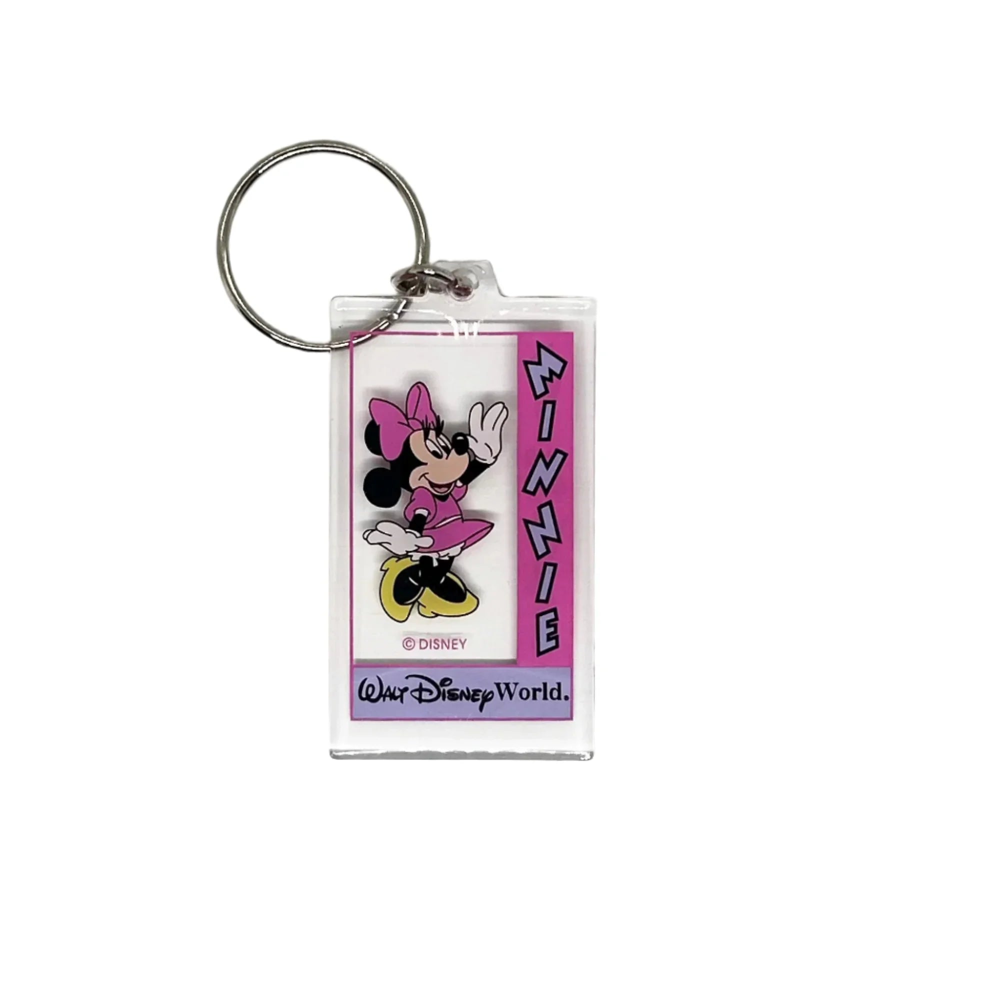 This Minnie Mouse keychain is too cute. It is made of clear acrylic, and shows Minnie Mouse in a pink dress, a pink bow, white gloves and yellow shoes. She has a big smile and is waving. The letters on the left side read "Minnie" in lavender with black border, on a bright pink background. Below Minnie is a purple banner with "Walt Disney World" in black